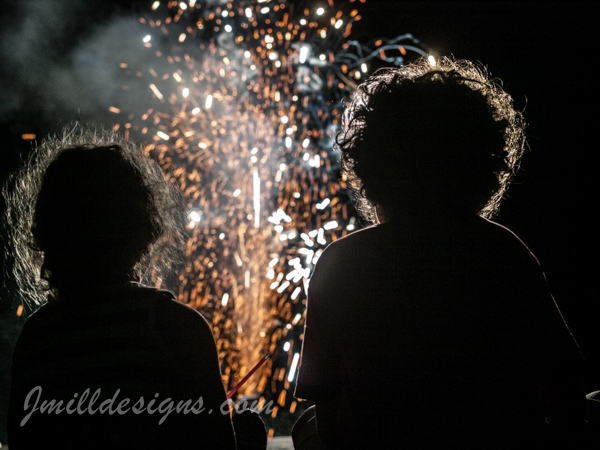 Photography of children silhouetted by fireworks