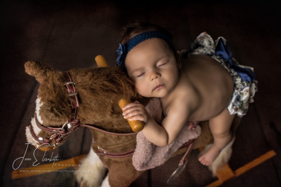 Portrait of baby girl on rocking horse