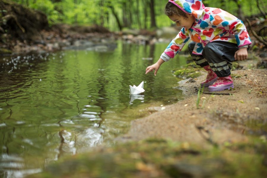 Little girl with paper boat